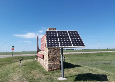 Solar with brick sign and grass.